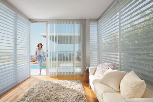 A living room with sheer window coverings.